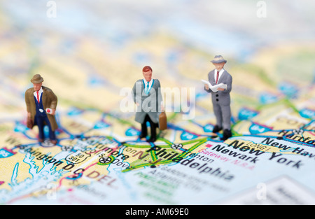 Three businessmen figures standing on map of East Coast Stock Photo