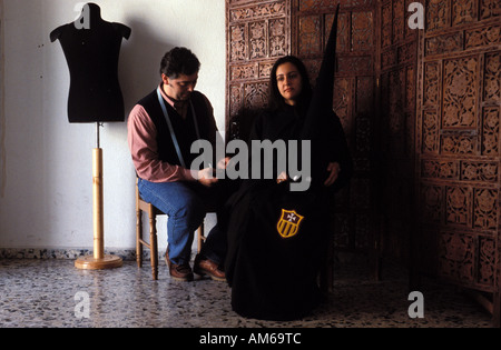 Jerez de la Frontera a tailor is taking measures for the traditional hooded costume Stock Photo
