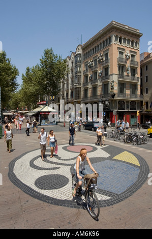 Las Ramblas. Pavement mosaic by Catalan artist Joan Miró in front of the Bruno Quadras building. Barcelona Spain Stock Photo