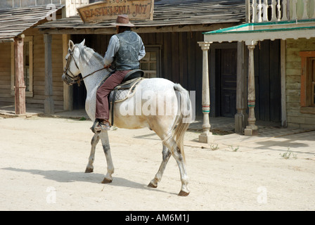 Cowboy riding in an American Western style town Stock Photo
