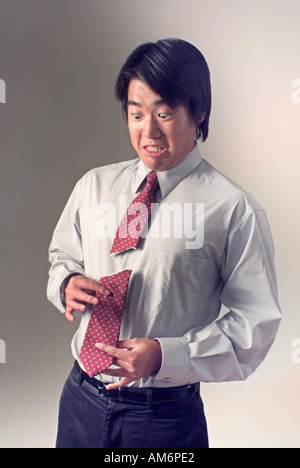 Businessman with tie cut in half Stock Photo