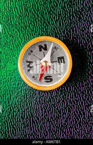 Close up of compass digitally enhanced on green background Stock Photo