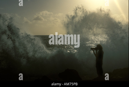 A photographer taking pictures of the blowholes on the northern coast Stock Photo