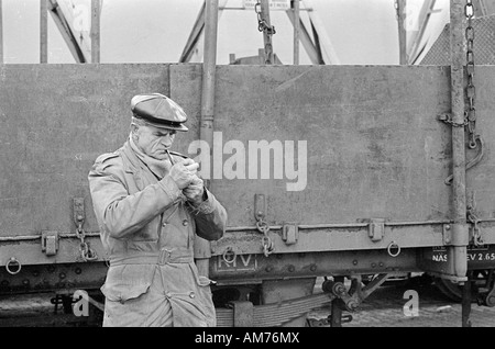 Man lighting his smoking pipe Stock Photo