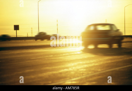 Nearing dusk, I captured vehicles commuting home after work along Interstate 80, near downtown Salt Lake City, Utah, USA. Stock Photo