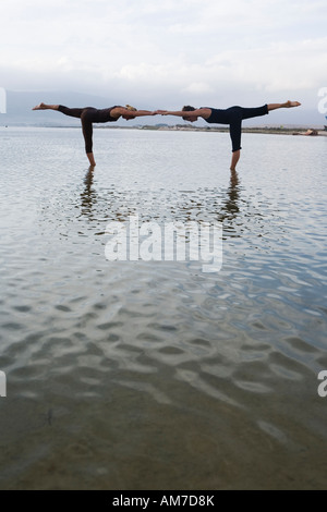 couple of women do yoga in water Stock Photo