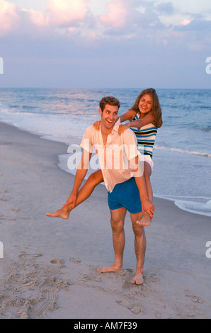 Couple in love posing at stone beach Stock Photo by ©AnnHaritonenko 75376699