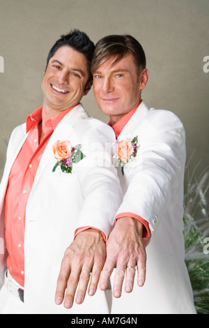 Gay couple showing off wedding rings Stock Photo