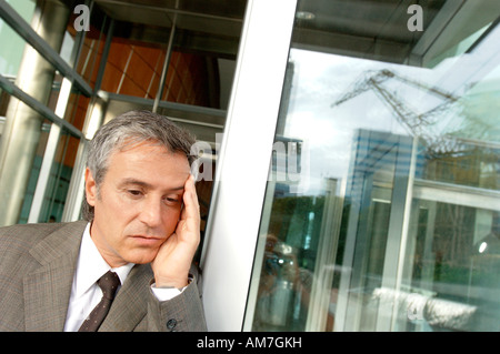 Businessman standing by window Stock Photo