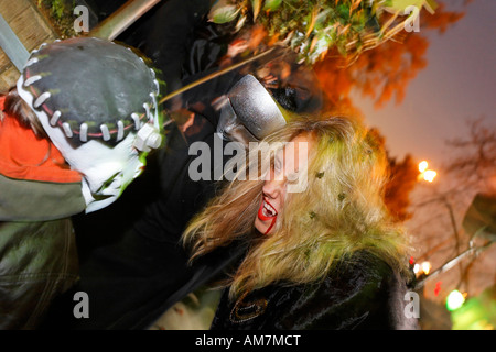 Young girl with vampire makeup frightening a young boy with Frankenstein mask, Halloween event for children, theatre museum Due Stock Photo