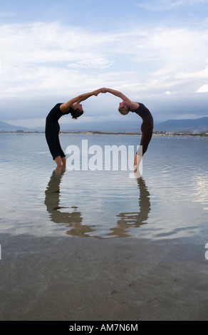 couple of woman friends pratice couple yoga in nature Stock Photo