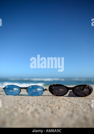 Two glasses laying on beach. Stock Photo