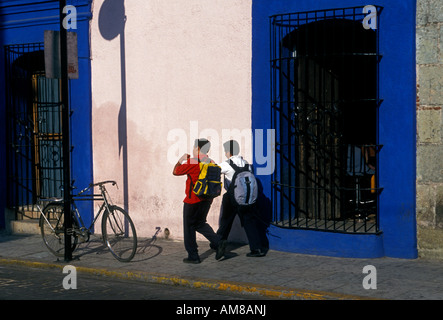 2 two Mexican people boys teenagers male students walking to class in capital city of Oaxaca de Juarez in Oaxaca State Mexico Stock Photo