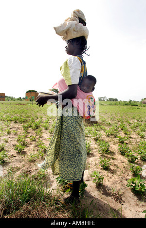 Fada N Gourma Burkina Faso August 23rd 2005 An Oue mother with her baby in a sling on her back Stock Photo