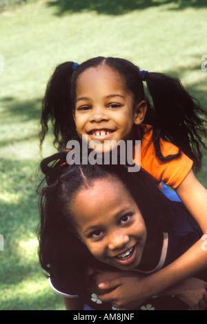 Sisters enjoying at park, portrait Stock Photo