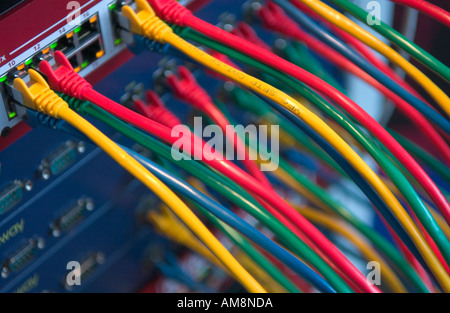 colored cables connected to ethernet hubs Stock Photo