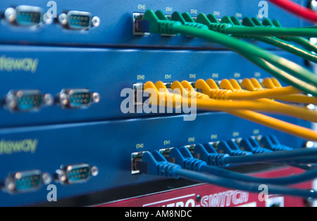 colored cables connected to ethernet hubs Stock Photo