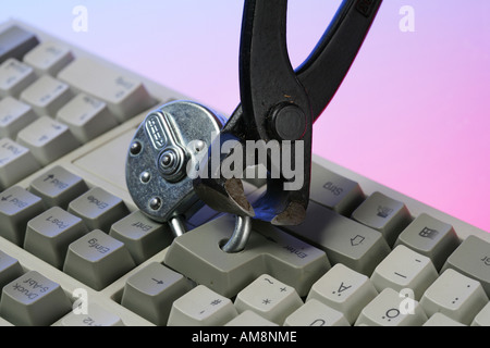 DEU, Germany : Symbolic photo, Internet and computer security. Computer keyboard with lock, breaking of the lock with a tong Stock Photo