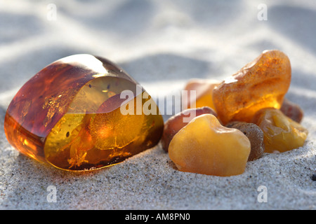 Amber stone, polished and unpolished (right) Stock Photo