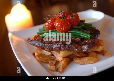 a plate of steak and chips in a restaurant, in Bristol, UK Stock Photo