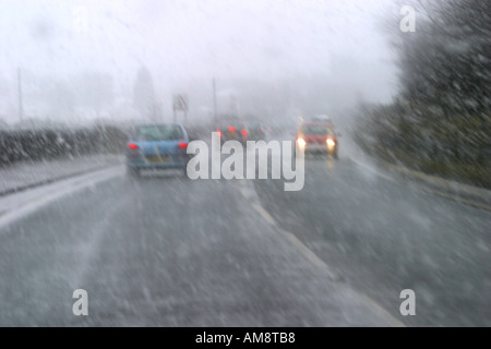 Urban road from in car with driving sleet and snow Stock Photo