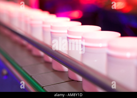 Pill bottles on production line at pharmaceutical factory Stock Photo