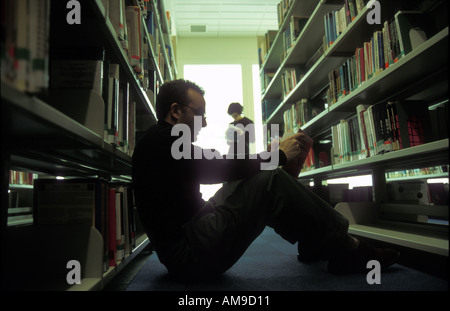 Male student studying in university library. Stock Photo