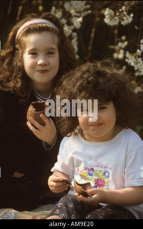 girls eating Easter eggs. Stock Photo