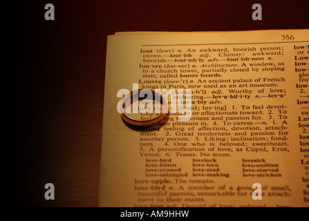 Love circled with a ring in a dictionary book Stock Photo