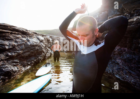 Two men in the water getting ready to surf. Stock Photo