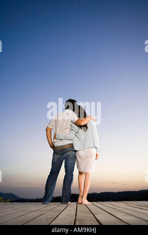 Couple being affectionate on a dock. Stock Photo