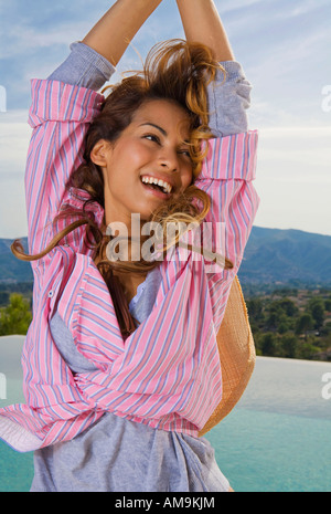 Beauty natural woman smiles with arms up outside. Stock Photo