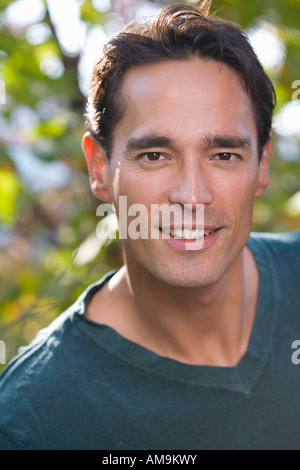 Man smiling outdoors looking at camera. Stock Photo