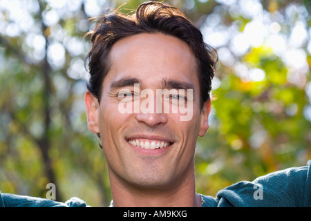 Man smiling looking at camera outdoors. Stock Photo