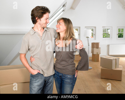 Couple moving into new home smiling. Stock Photo