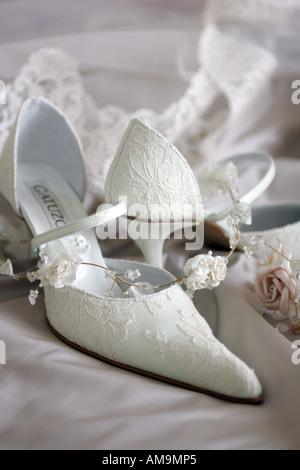 A portrait of a pair of white womens wedding shoes seen here in a still life picture. Stock Photo