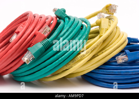 4 reels of coloured ethernet cable leaning agaist each other Stock Photo