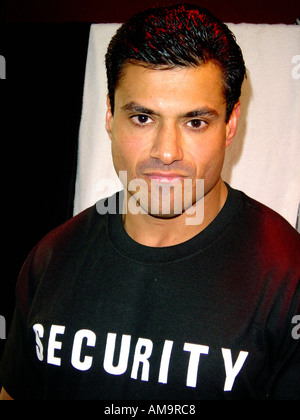 Portrait of a Male Security Guard or Bouncer of Hispanic Ethnicity Wearing a Black Tee Shirt Stock Photo