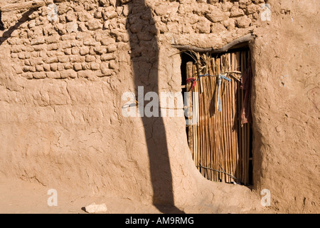 Old wooden door in mud brick wall in Egypt, North Africa Stock Photo