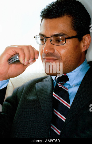 Portrait of a Businessman of Hispanic Ethnicity He is Holding a Cellular Telephone Stock Photo