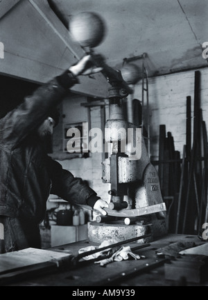 man using a machine press photographed in Black and white Stock Photo
