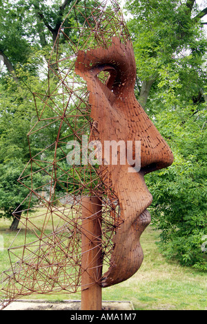 rick Kirby vertical face steel metal sculpture rust oxidise brown red park tree garden profile fabricate weld construct build cr Stock Photo