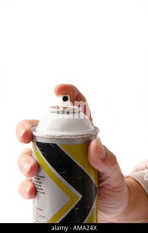 Hand holding an aerosol can with it pointing at camera. Stock Photo