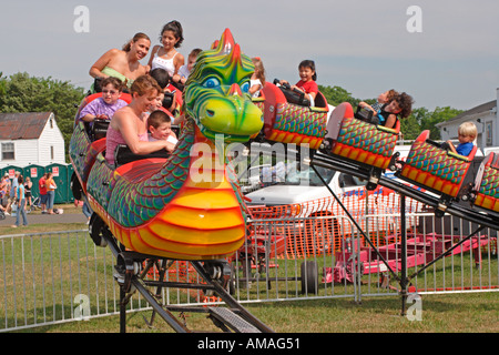 Children ride carnival dragon roller coaster thrill fun excite laugh ...