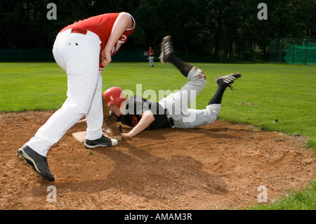 A baseball player sliding into a base Stock Photo