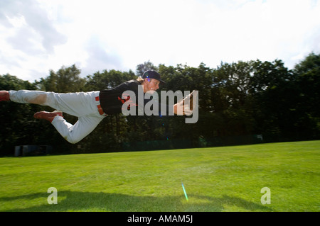 A baseball player diving to catch the ball Stock Photo