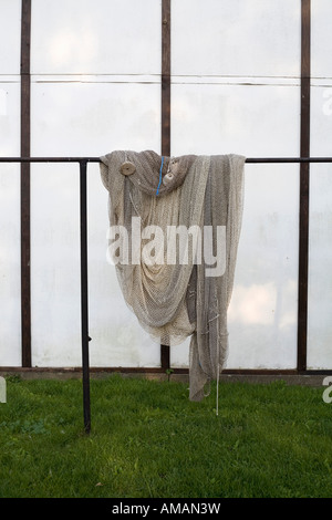 Fishing Net Railing A fishing net hanging on railing Stock Photo - Alamy