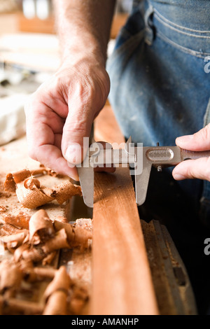 Detail of a carpenter measuring wood Stock Photo