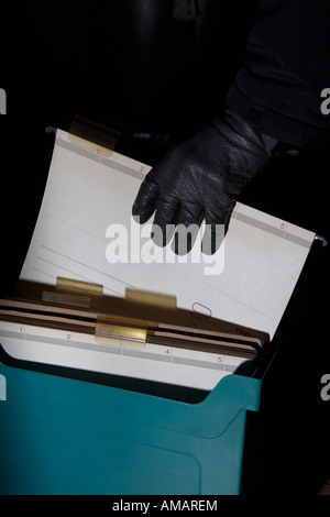 Detail of a hand with a leather glove holding a file Stock Photo