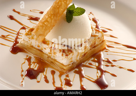 ice-cream dessert, lemon sherbet, apple cake with  meringue, caramel sauce and lemon ice-cream Stock Photo